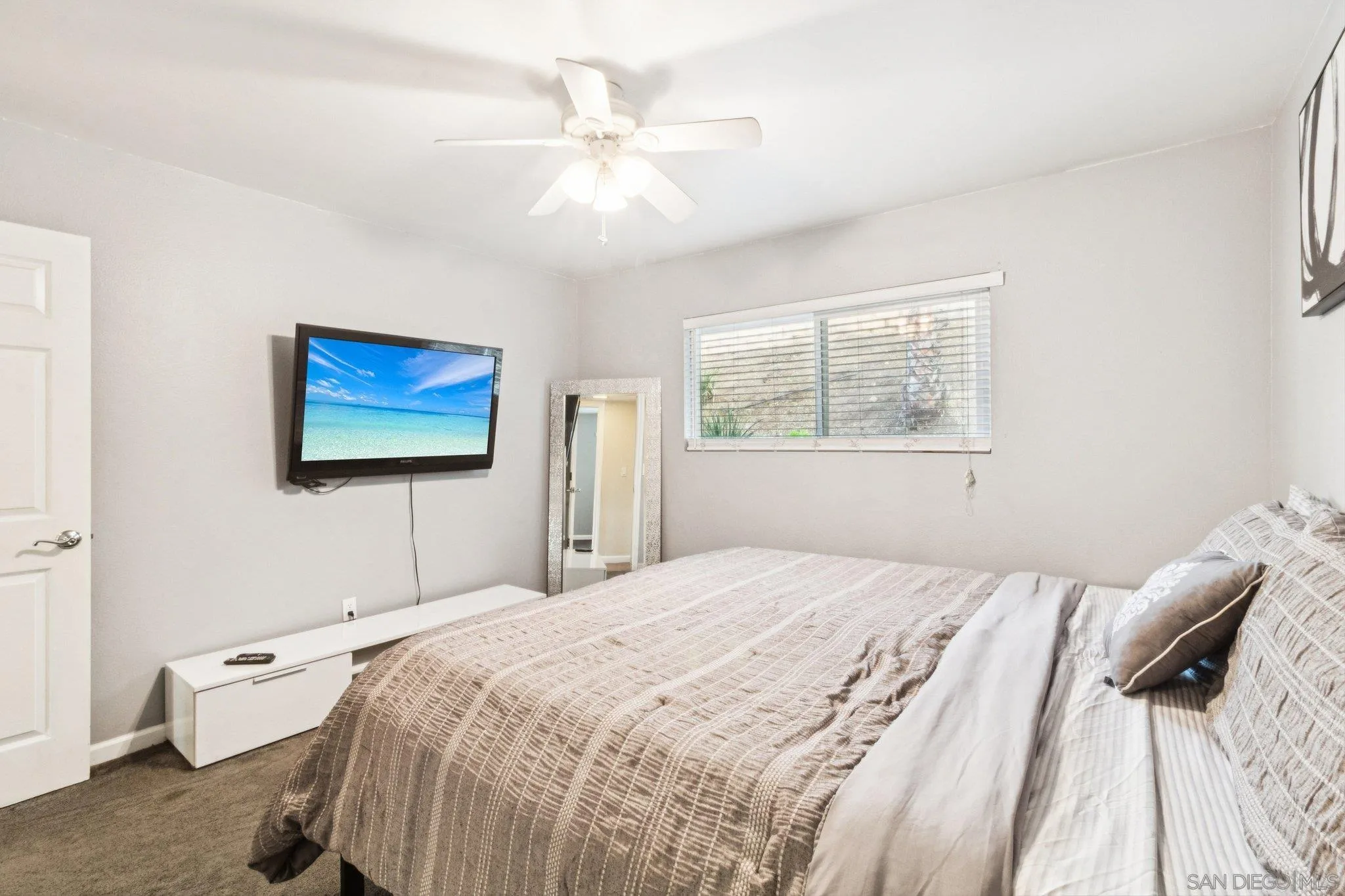 3365 South Bonita Street Spring Valley, CA 91977 - Photo 28 of 32 a bedroom with a bed and a chandelier