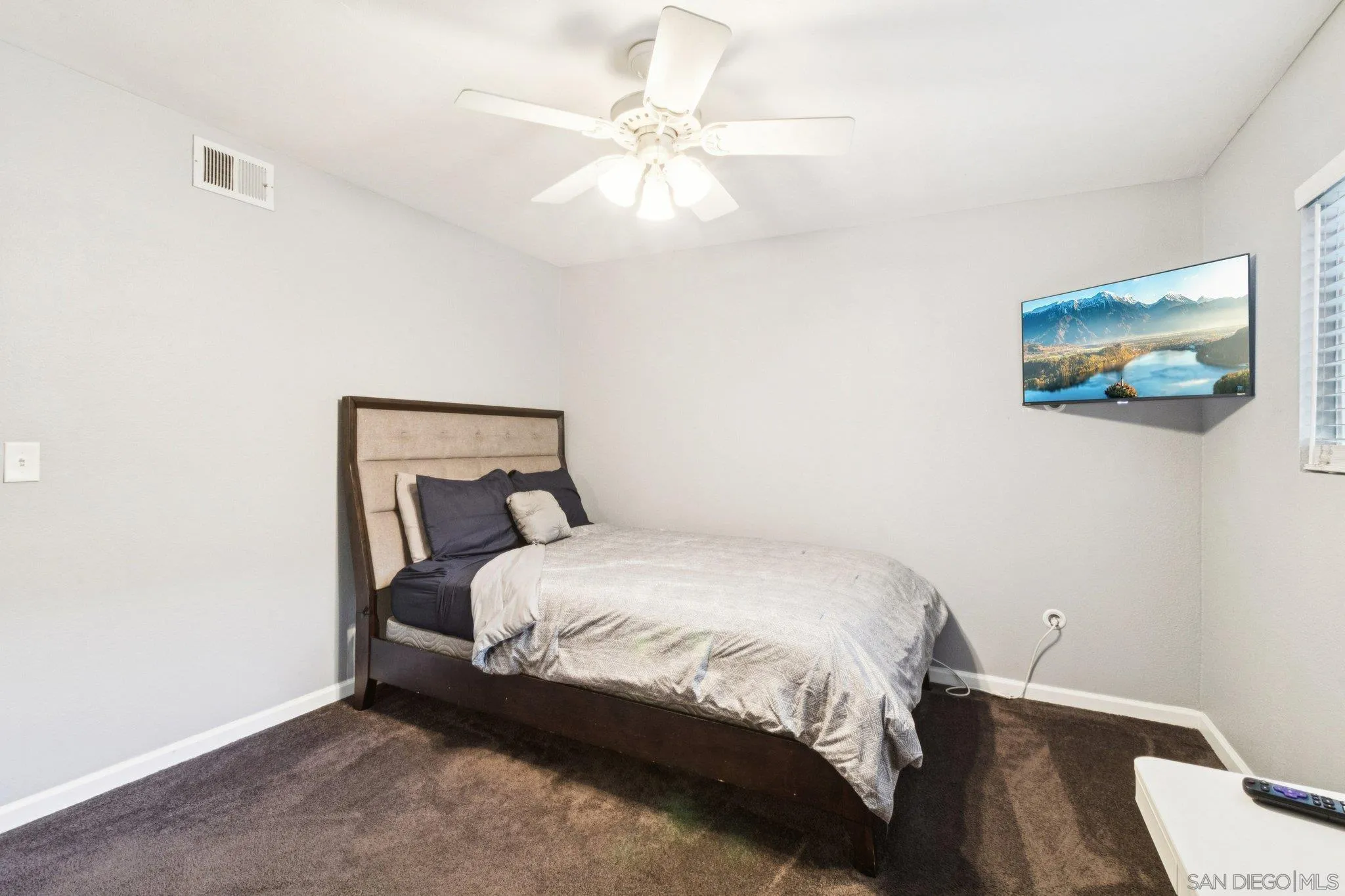 3365 South Bonita Street Spring Valley, CA 91977 - Photo 30 of 32 a bedroom with a bed and a painting on the wall