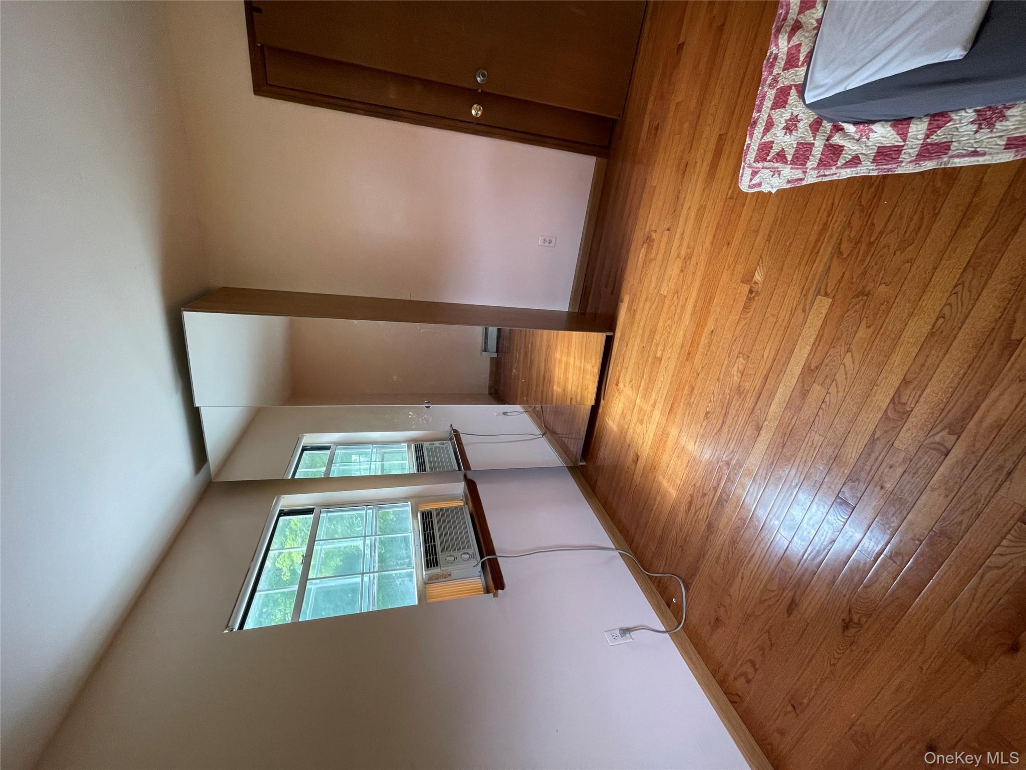 257 Lake Road Salisbury Mills, NY 12577 - Photo 11 of 30 a view of an empty room with wooden floor and a window