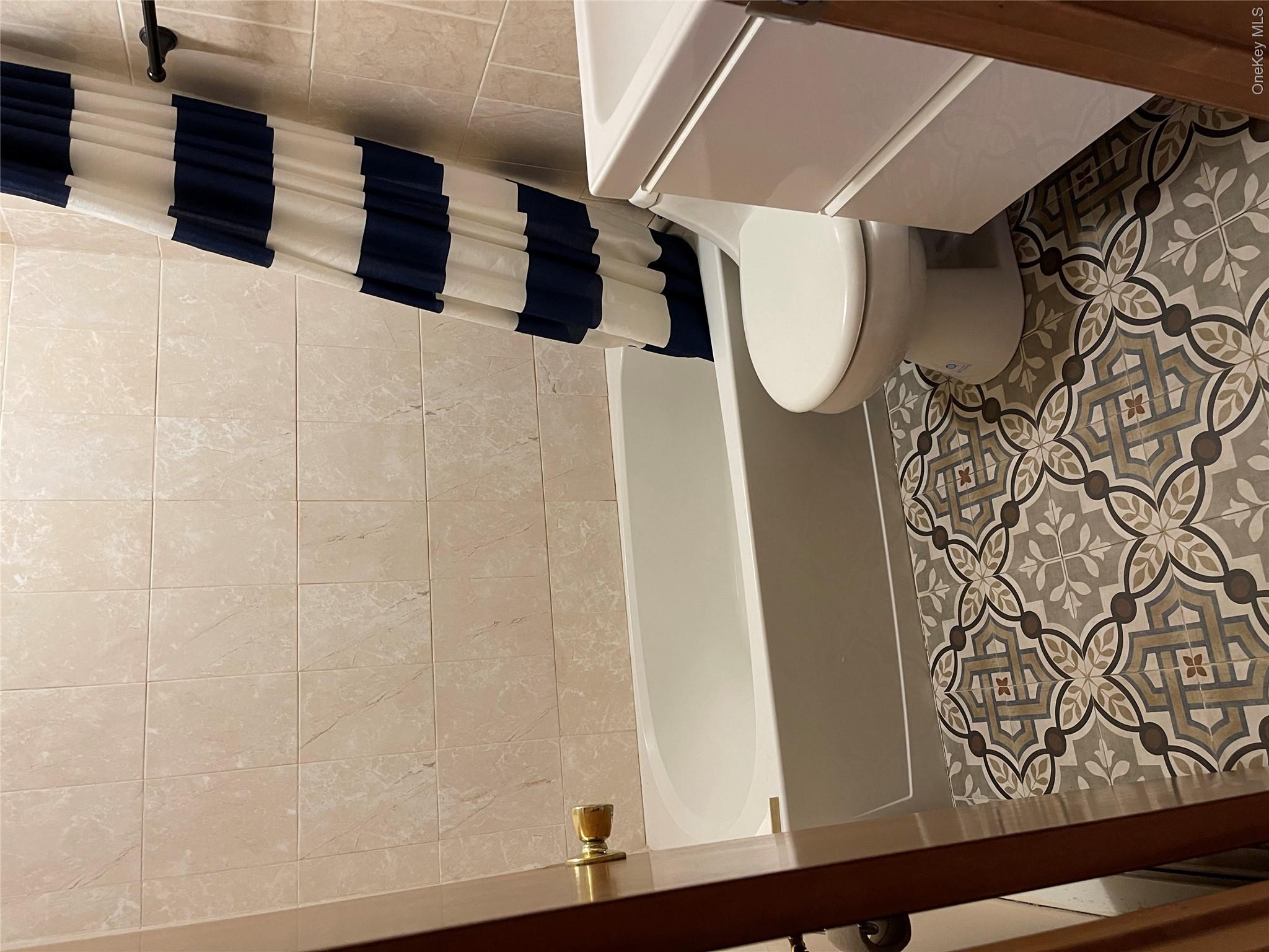 257 Lake Road Salisbury Mills, NY 12577 - Photo 12 of 30 Bathroom featuring vanity, shower / tub combo, tile patterned flooring, and tile walls