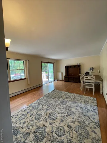 a view of a livingroom with furniture and an empty room