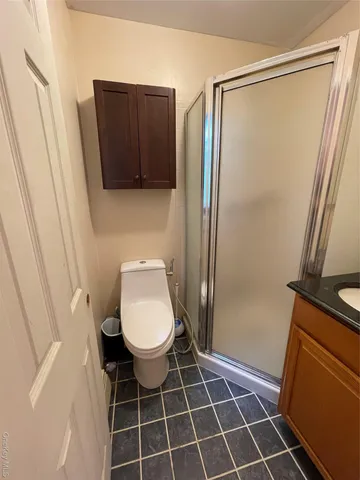 a bathroom with a toilet and a shower