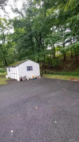 a view of a field with large trees