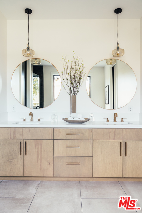 3207 Earlmar Drive Los Angeles, CA 90064 - Photo 38 of 51 a bathroom with a sink and a mirror