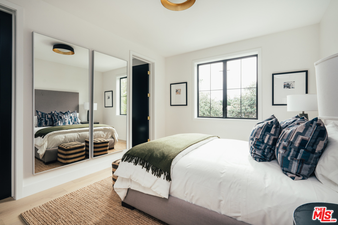 3207 Earlmar Drive Los Angeles, CA 90064 - Photo 43 of 51 a bedroom with a bed and a mirror