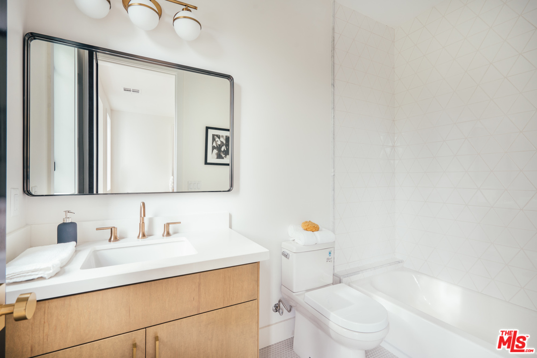 3207 Earlmar Drive Los Angeles, CA 90064 - Photo 45 of 51 a bathroom with a sink and a mirror