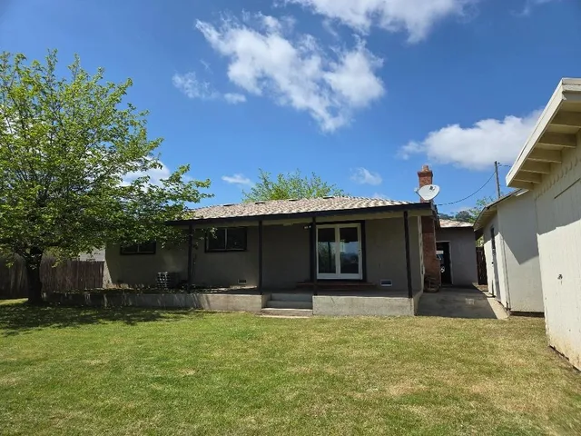 a front view of house with yard and trees