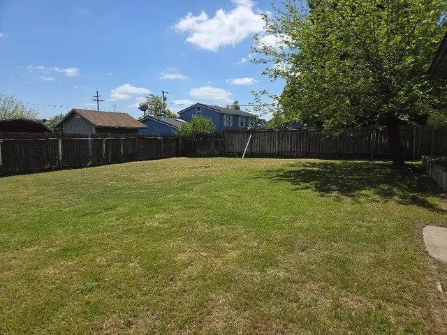 a backyard of a house with lots of green space