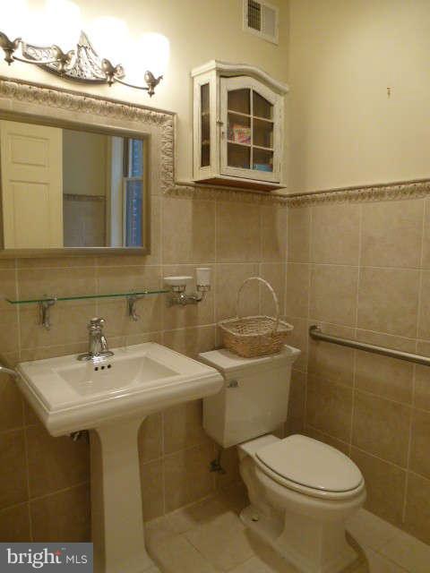 618 4th Street Northeast Washington, DC 20002 - Photo 12 of 30 a bathroom with a sink toilet and mirror