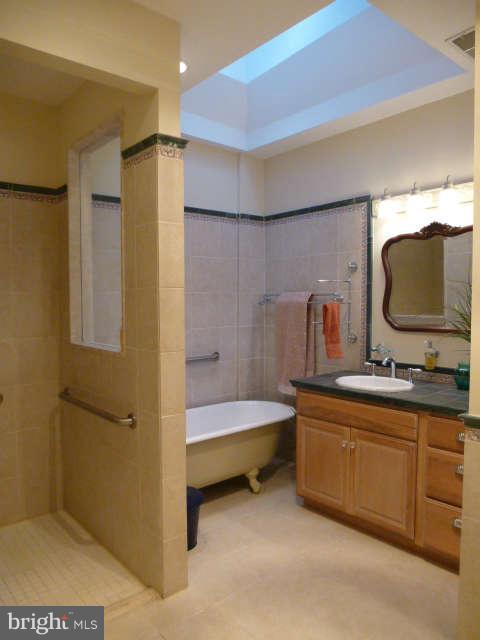 618 4th Street Northeast Washington, DC 20002 - Photo 19 of 30 a bathroom with a tub sink and mirror