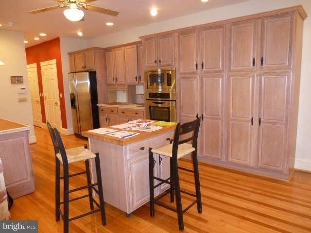618 4th Street Northeast Washington, DC 20002 - Photo 7 of 30 a kitchen with a table chairs refrigerator and microwave