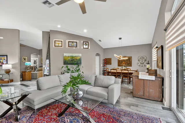 a living room with furniture a rug and a flat screen tv