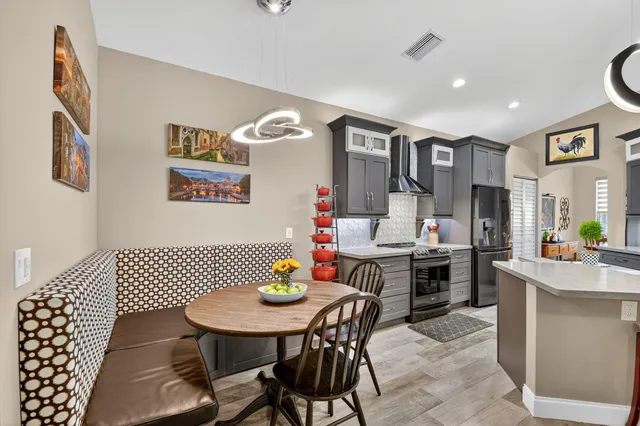 a bedroom with a bed and a lamp on dresser