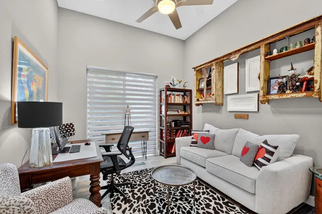 a patio with a table and chairs under an umbrella