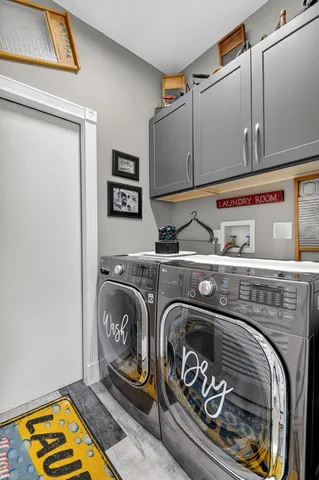a front view of a house with a garden and a tree