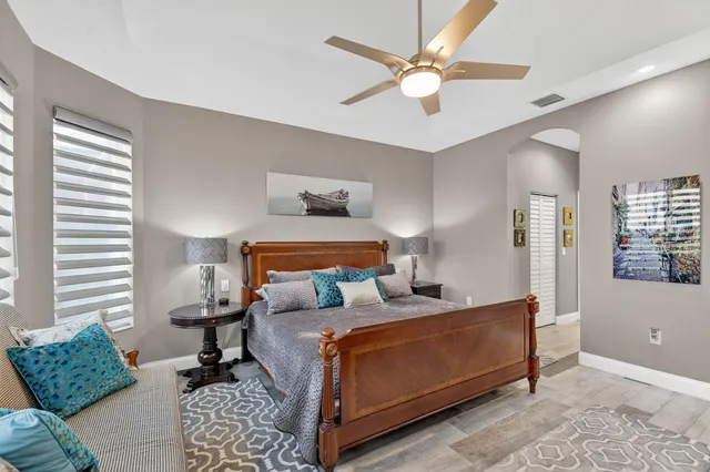 an aerial view of a city with lots of residential buildings ocean and mountain view in back