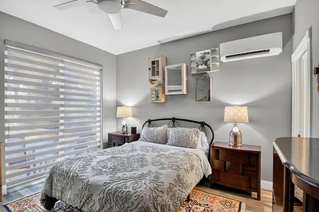 a view of a hallway with wooden floor and a chandelier