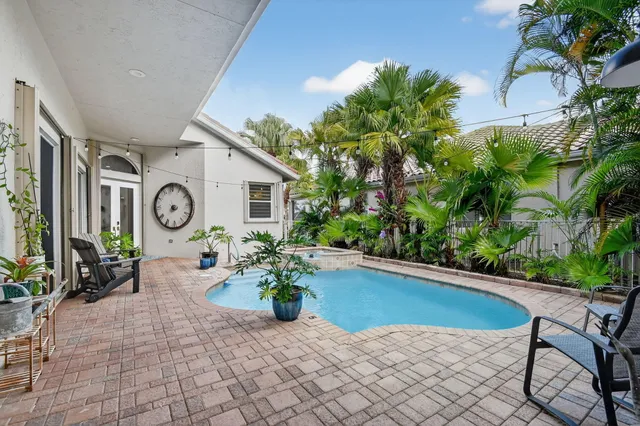 a living room with furniture a large window and a flat screen tv