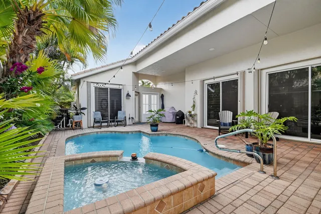 a living room with furniture kitchen view and a window