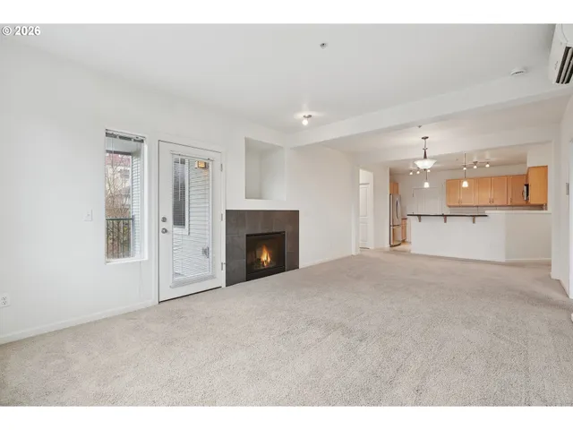 a view of empty room with a fireplace