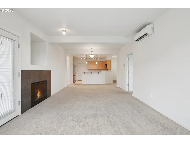 a view of an empty room with a fireplace