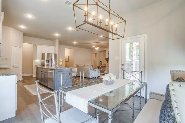 a bedroom with a bed flat screen tv and a window
