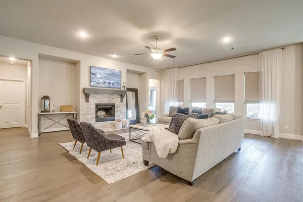 a kitchen with granite countertop stainless steel appliances a stove a sink a refrigerator a dining table and chairs