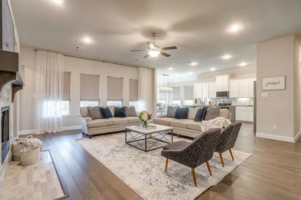 a kitchen with kitchen island granite countertop a sink cabinets and wooden floor