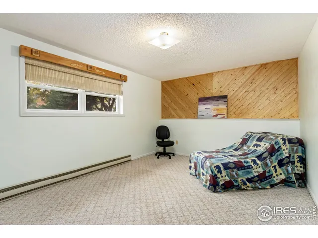 a bedroom with a bed and a desk