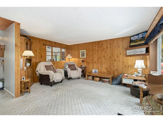 a bedroom with furniture and a large window