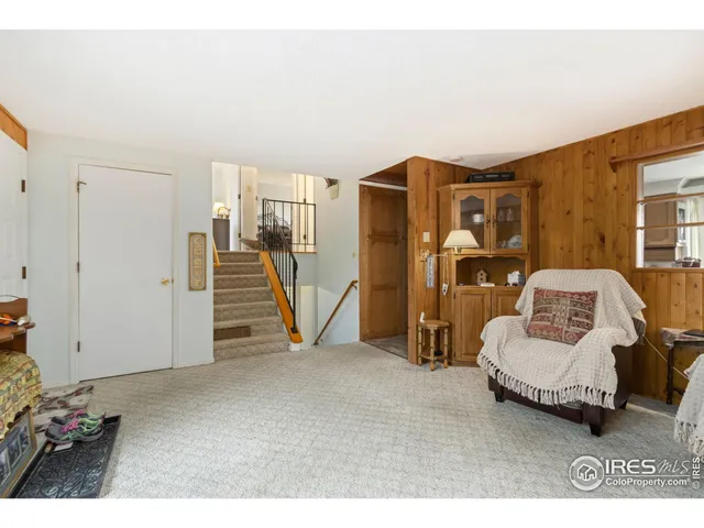 a living room with furniture and a walk in closet