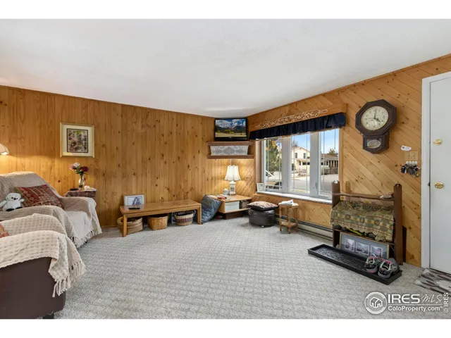 a bedroom with furniture and a large window