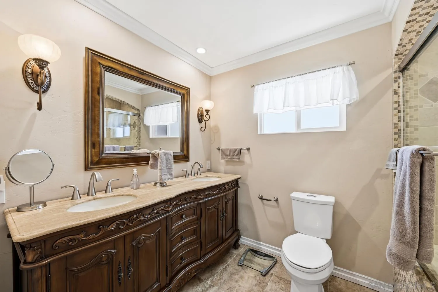 944 Hillhaven Road Escondido, CA 92027 - Photo 13 of 31 a bathroom with a toilet sink double vanity and mirror