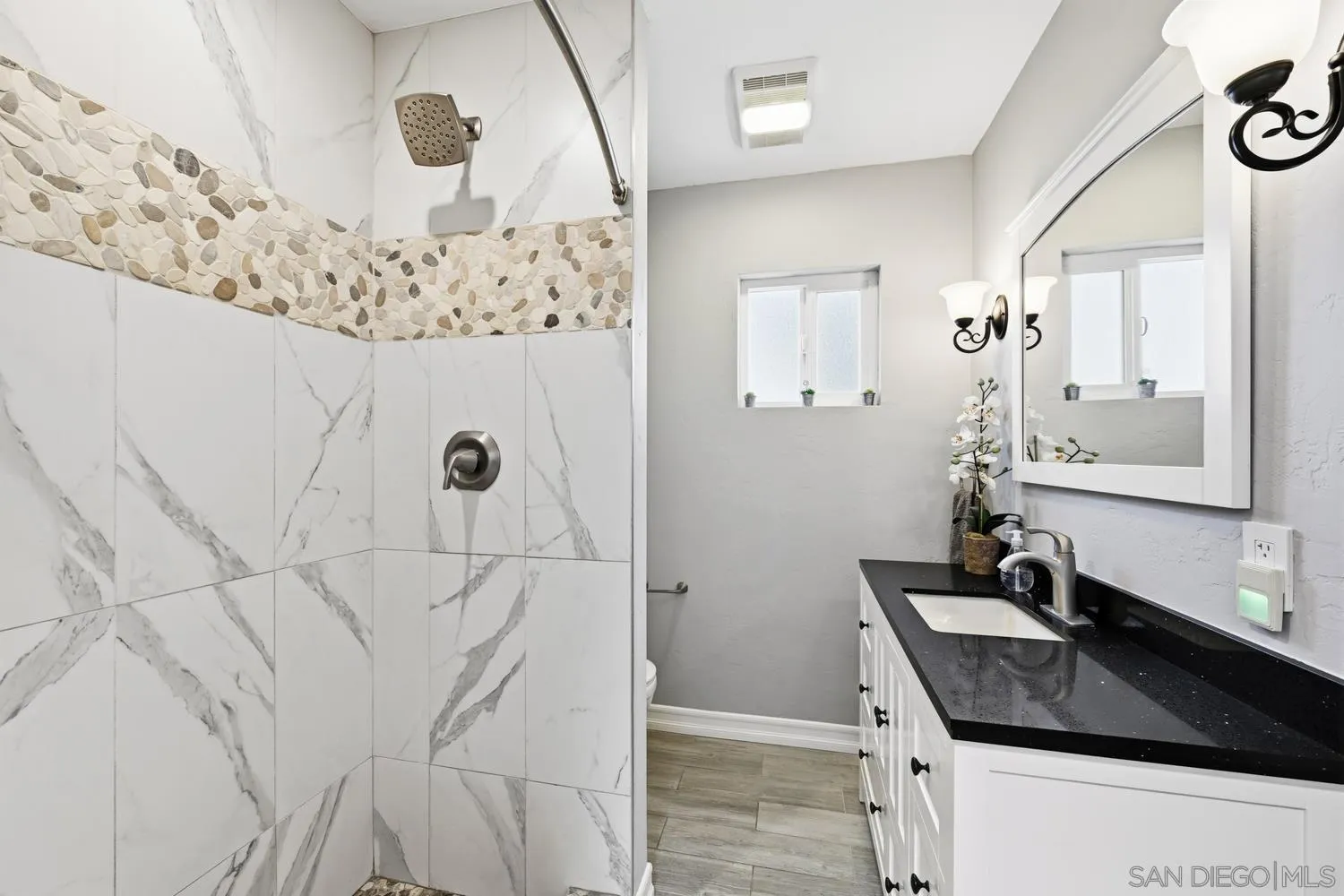944 Hillhaven Road Escondido, CA 92027 - Photo 19 of 31 a bathroom with a granite countertop sink a mirror and shower