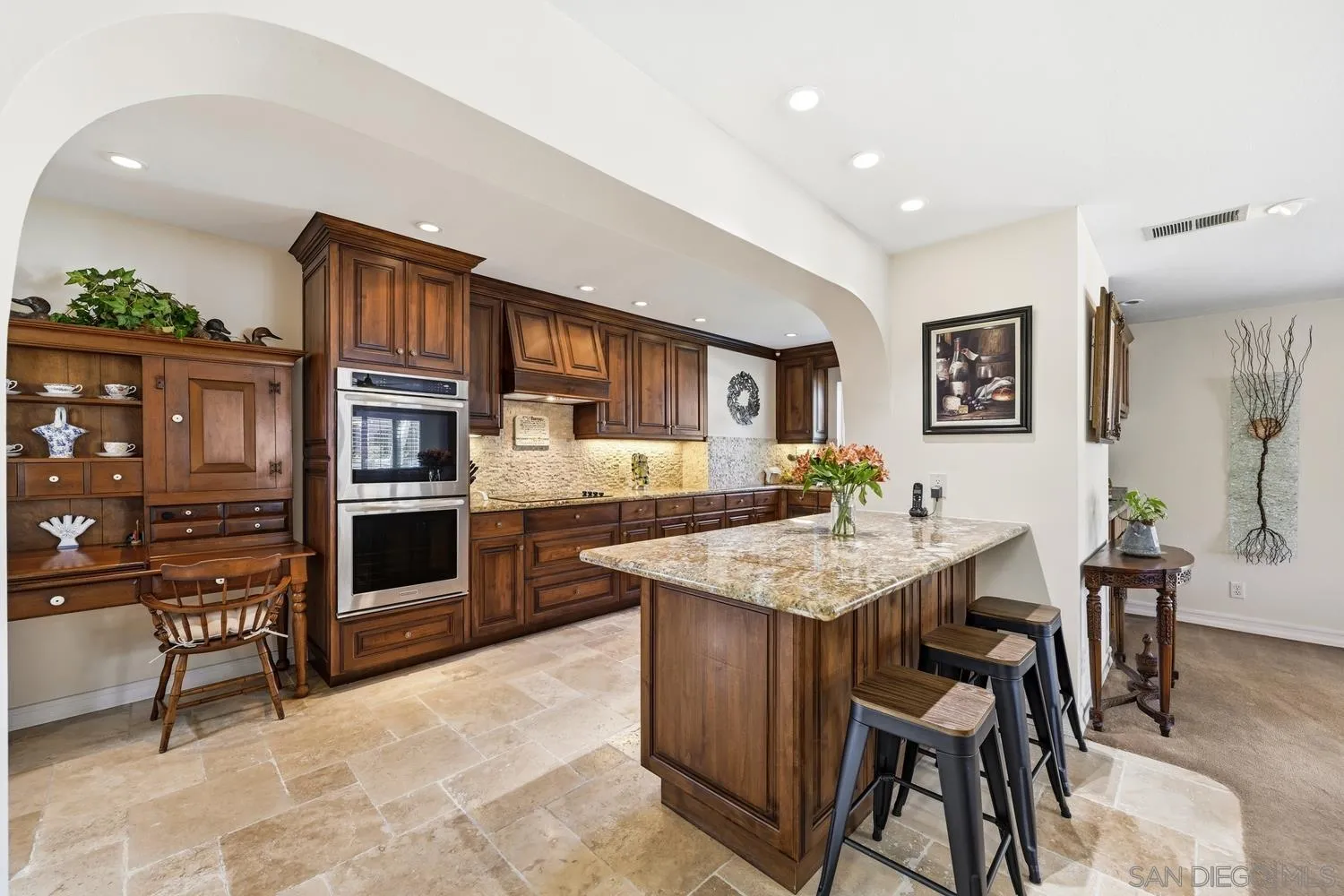 944 Hillhaven Road Escondido, CA 92027 - Photo 5 of 31 a kitchen with stainless steel appliances kitchen island granite countertop a table chairs and a refrigerator