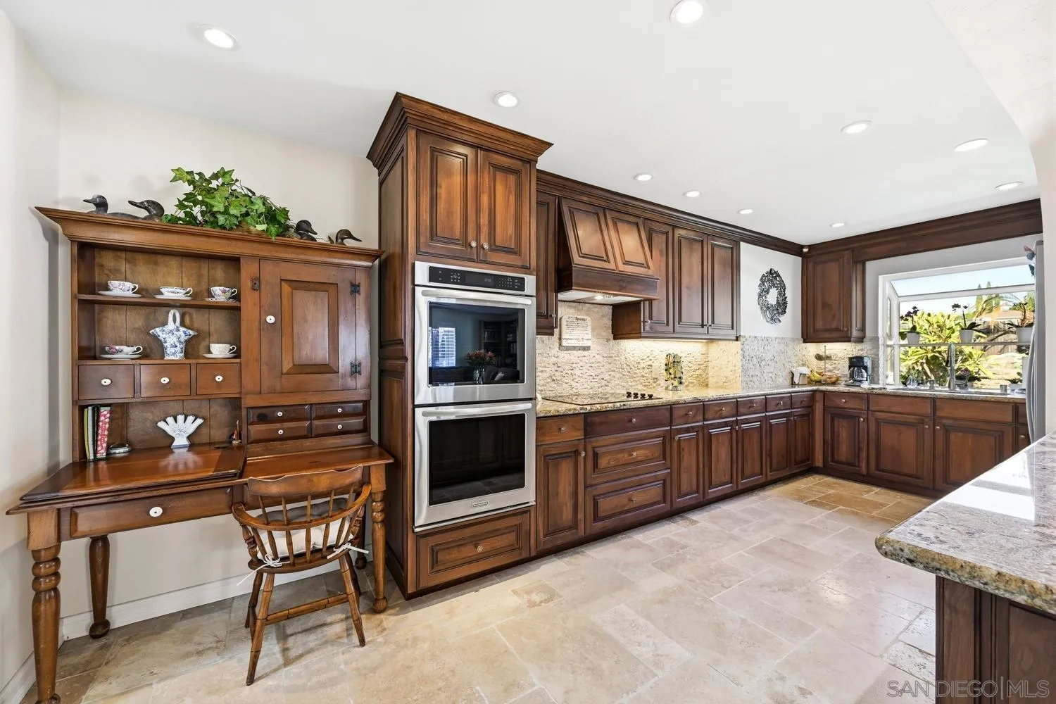 944 Hillhaven Road Escondido, CA 92027 - Photo 6 of 31 a kitchen with stainless steel appliances kitchen island granite countertop a stove a sink and a microwave