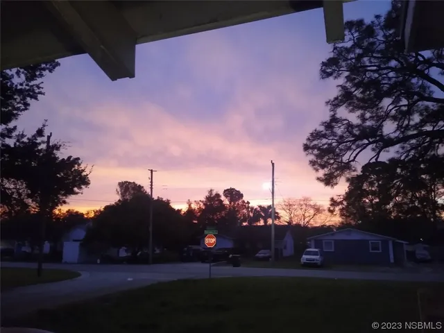 a front view of a house with a garden and yard