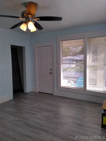 a kitchen with a sink cabinets and wooden floor