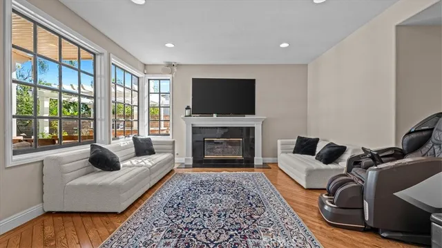 a living room with furniture a flat screen tv and a fireplace