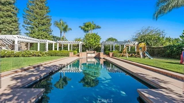a view of house with garden space and sitting area