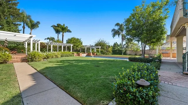 a view of a patio with table and chairs with wooden floor and fence