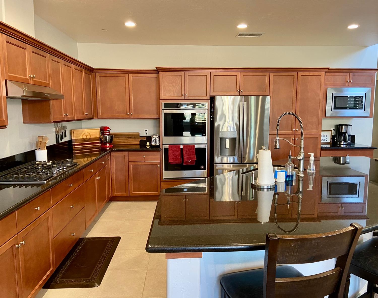 3967 Lincoln Avenue Clovis, CA 93611 - Photo 11 of 70 a kitchen with lots of counter top space cabinets and stainless steel appliances