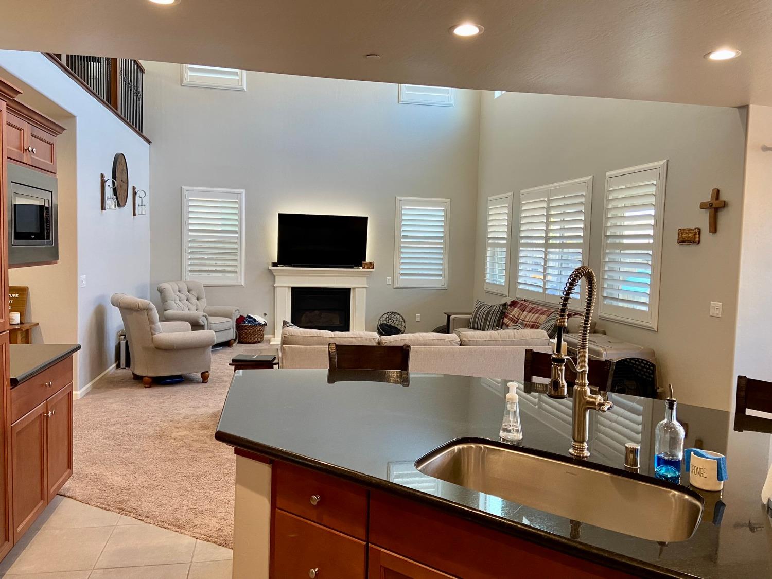 3967 Lincoln Avenue Clovis, CA 93611 - Photo 18 of 70 a living room with furniture a fireplace and a flat screen tv