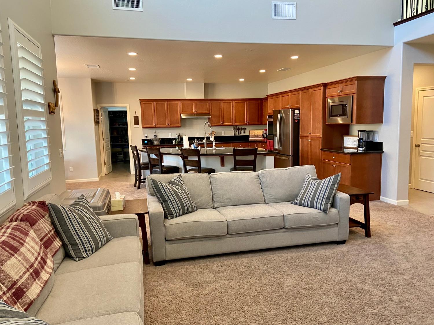 3967 Lincoln Avenue Clovis, CA 93611 - Photo 19 of 70 a living room with furniture kitchen view and a chandelier