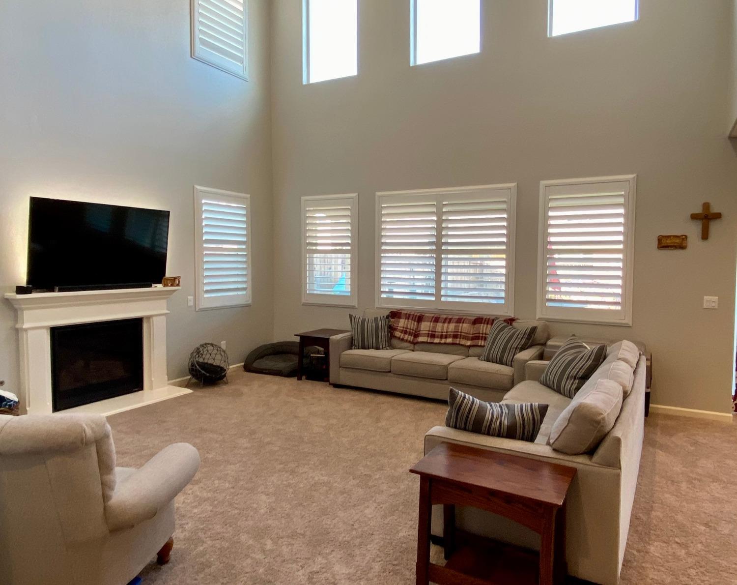 3967 Lincoln Avenue Clovis, CA 93611 - Photo 20 of 70 a living room with furniture a fireplace and a flat screen tv