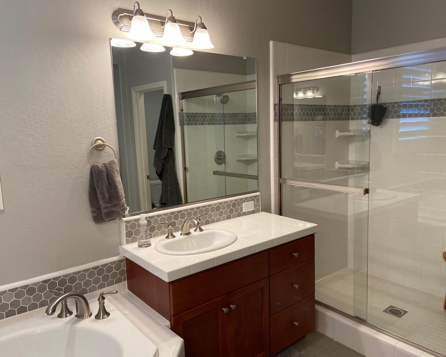 3967 Lincoln Avenue Clovis, CA 93611 - Photo 39 of 70 a bathroom with a sink mirror and shower