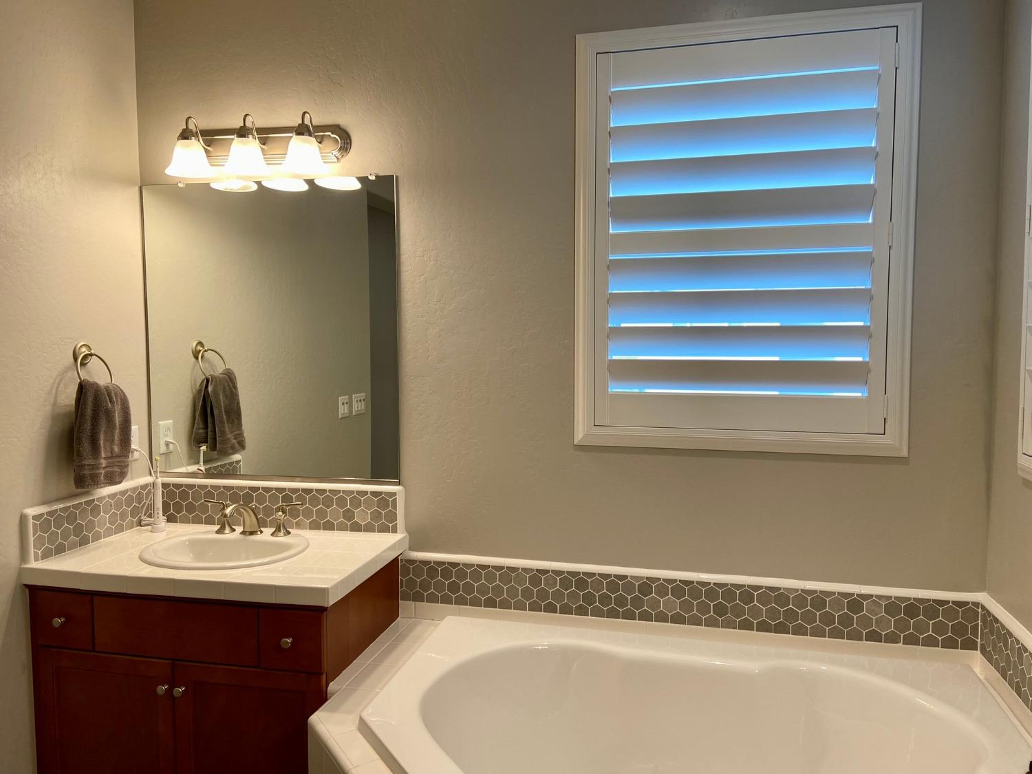 3967 Lincoln Avenue Clovis, CA 93611 - Photo 41 of 70 a bathroom with a sink and a mirror