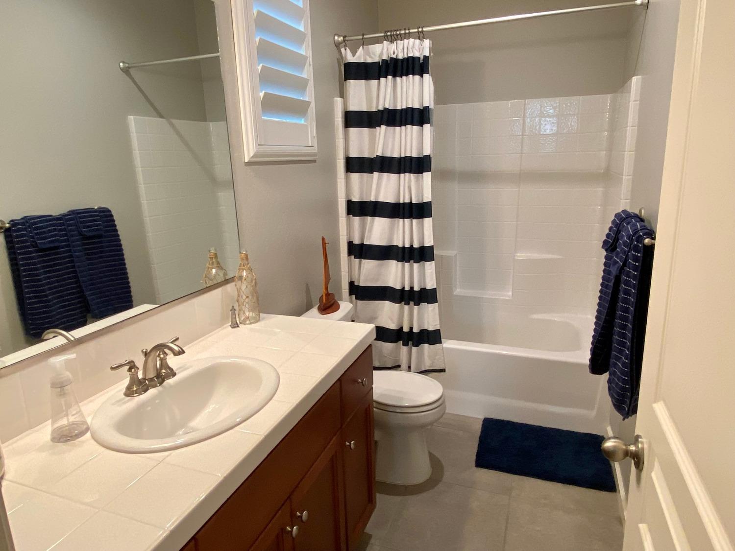 3967 Lincoln Avenue Clovis, CA 93611 - Photo 60 of 70 a bathroom with a sink toilet a shower and a bathtub