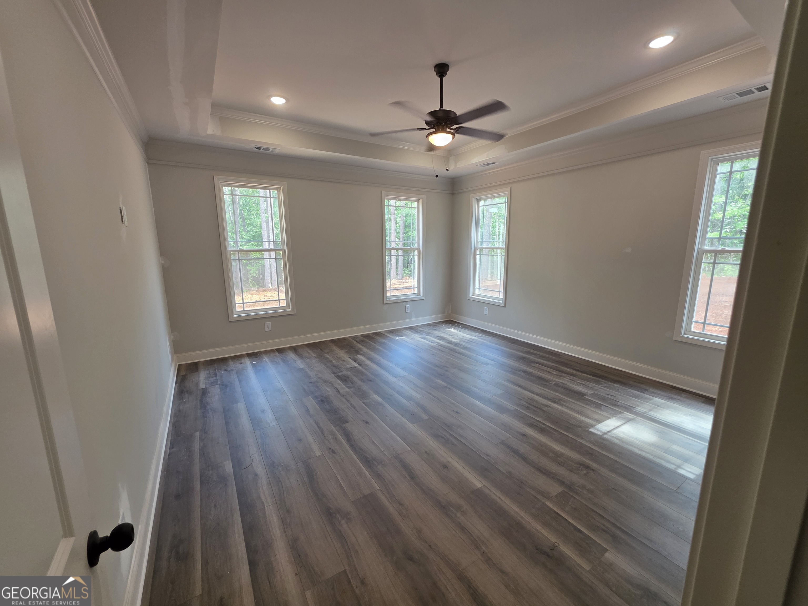 215 Panola Road Jackson, GA 30233 - Photo 8 of 16 a view of an empty room with wooden floor and a window