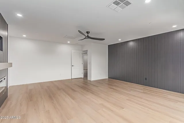 a view of an empty room with a ceiling fan